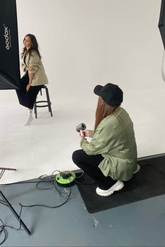Behind the scenes: a client being photographed on the studio set.