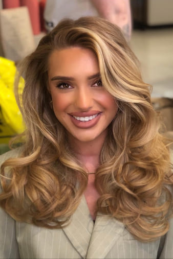 Client with long, thick hair in a bouncy blow-dry.